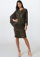 Woman wearing a patterned dress on a white background